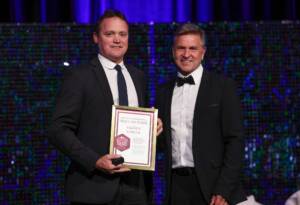 Darren O'Brien with Dean Warren (AFLQ Chair) at the 2023 AFLQ Hall of Fame Induction evening