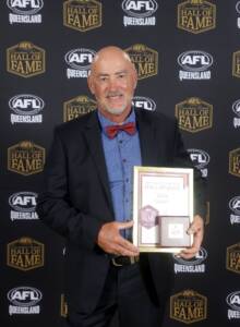 Zane Taylor with his award at the 2023 AFLQ Hall of Fame Induction evening